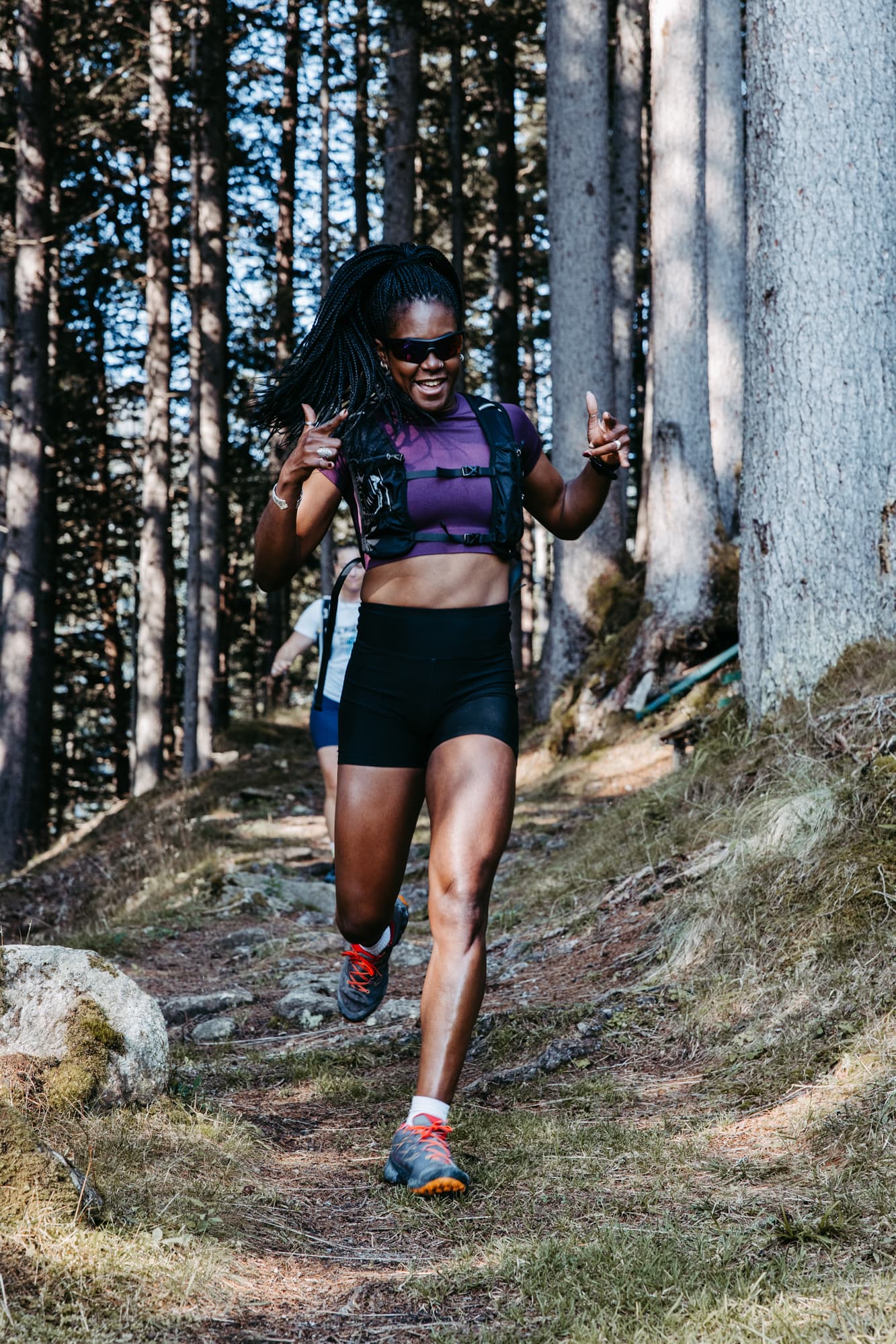 Joyful runner celebrating in forest